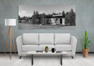 Black and white photograph of an overgrown roadside motel