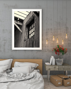 Light through an old window beneath exposed roof beams