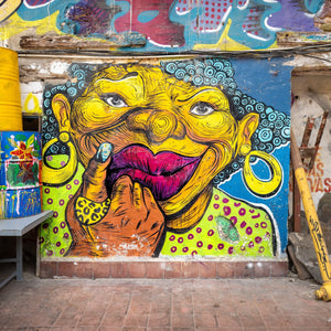 Panama City street art portrait with hoop earrings and turquoise curls