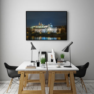Prague Castle and cathedral rising above the waterfront beneath a deep blue sky