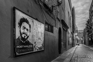 Black and white Dublin lane with a large Post Malone poster in the foreground