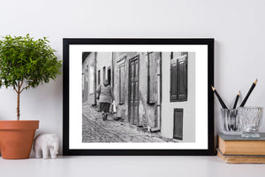 Weathered doors and closed wooden shutters along a cobbled Romanian lane