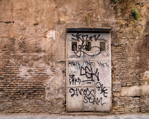 Colour photograph of a Roman doorway surrounded by exposed brick and ochre plaster