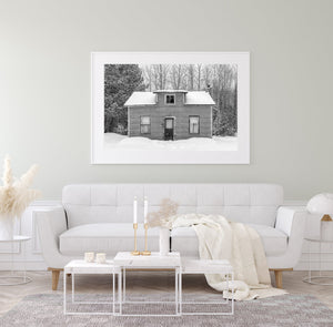 Snow-covered roof and worn window frames on a quiet Ontario home