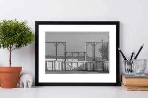 Wooden rink entrance with tall wire fencing and an overhead light