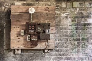 Colour photograph of abandoned factory wiring and corroded electrical boxes