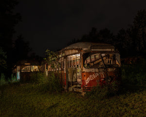 Vintage transit buses decaying in the dark city shadows