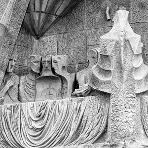 Angular stone figures around the Last Supper table at Sagrada Familia