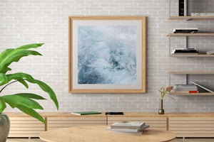 Pale turquoise water and white foam create flowing abstract textures.