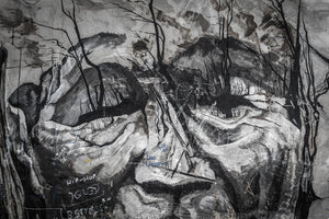 Close-up of a weathered face mural with scattered graffiti in Ushuaia, Argentina