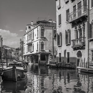 Old Venice facades with shuttered windows and balconies above a narrow canal