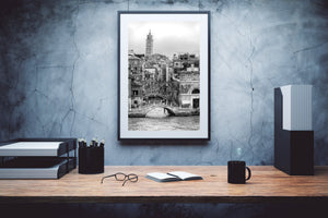Monochrome Venice architecture with layered bridges and a distant brick bell tower