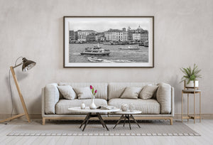 A busy Venice waterway with tour boats and a long row of historic buildings