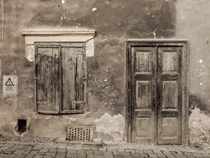 Sepia photograph of an aged Romanian doorway and shuttered window