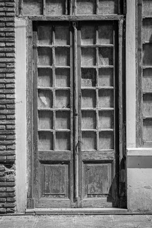 Old Uruguay doorway with repeated window panes and peeling wooden panels
