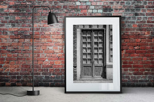 Black and white architectural photograph of aged wooden double doors