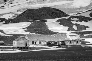 Black and white photograph of weathered buildings at Whalers Bay
