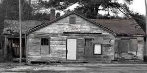 Old rural structure marked with Marc’s Place sign