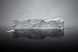 Gentle Snowfall over Lone Antarctic Iceberg