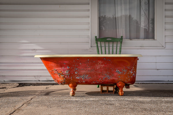 Close-up of an antique bathtub on Route 66, showcasing intricate details and weathered texture.