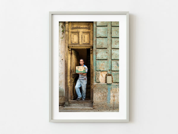Man walking out of the aged door in Cuban building | Photo Art Print fine art photographic print