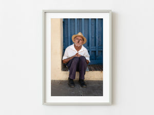 Older man smoking a cigar in doorway Trinidad Cuba | Photo Art Print fine art photographic print