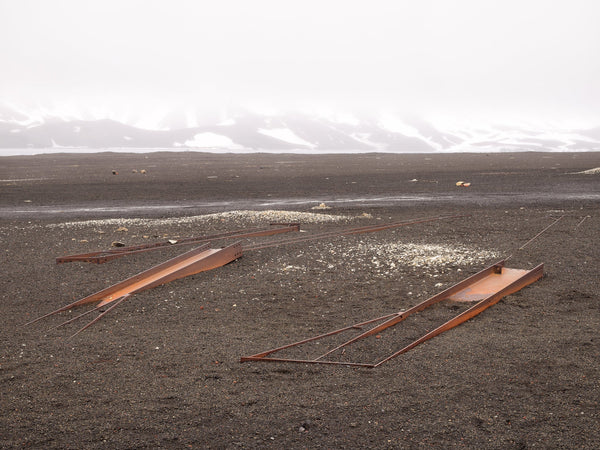 Steel girders lying in the sand at Whalers Bay Station Antarctica | Photo Art Print fine art photographic print